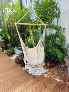 a hammock in a garden with trees and plants at Beautiful garden 3 bedroom villa close to beach in Plai Laem +35 photos