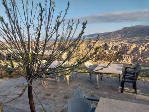 a table and chairs with a view of the grand canyon at Al -Nawatef Eco Lodge- Dana Nature Reserve in Dana