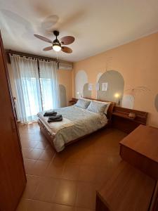 a bedroom with a bed and a ceiling fan at Domus Ciampino 4 bedrooms apartment in Ciampino