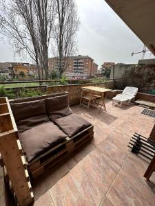 a bed on a patio with a table and chairs at Domus Ciampino 4 bedrooms apartment in Ciampino