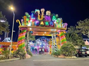 a carnival ride with a colorful arch at night at -Belle vue-Villa duplex-AC-jardin-parking in Alignan-du-Vent