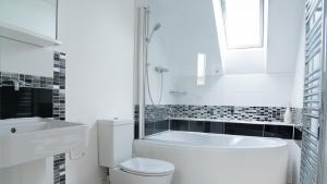 a white bathroom with a toilet and a sink at Superb 4BD Stay in Wyton and Houghton Village in Wyton +19 photos