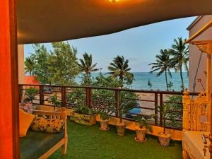 a balcony with a view of the ocean at Shanzu Oceanline Apartments La Mera in Mombasa