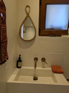 a bathroom with a sink and a mirror at Le Daou Sormiou in Marseille +14 photos