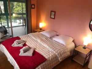 a bedroom with a bed with towels on it at Villa Prune 200m 5 chambres avec piscine et garage in Aix-les-Bains +58 photos