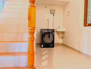 a washing machine in a room with a pole at Yellowra Farmstay Tiruvannamalai in Tiruvannāmalai +31 photos