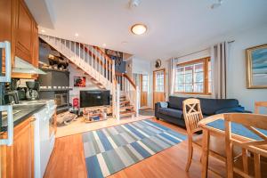 a kitchen and living room with a couch and stairs at Levinalppi 2 App 8 in Kittilä