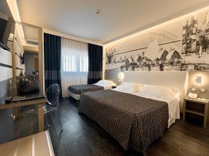 a hotel room with two beds and a television at The Sydney Hotel in Bologna