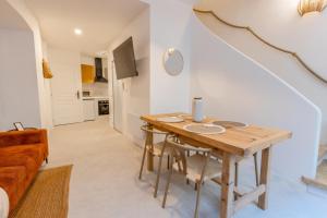 a living room with a wooden table and a couch at Pause méditerranéenne en plein centre in Béziers +10 photos