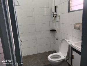 a bathroom with a toilet and a sink at Homestay Klang in Klang +11 photos