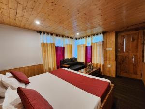 a bedroom with a bed and a chair in a room at Green Sanctuary Farmstay Sainj in Sainj
