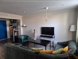a living room with a couch and a table at Apartment in central Öregrund in Öregrund