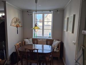 a dining room with a table and chairs and a window at Apartment in central Öregrund in Öregrund