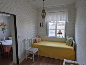 a bedroom with a bed and a window and a table at Apartment in central Öregrund in Öregrund