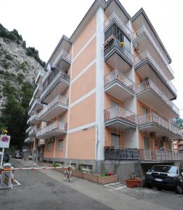 an apartment building with a car parked in a parking lot at Tizi Apartments Porto in Maiori