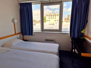 Postel nebo postele na pokoji v ubytování Arche Hotel