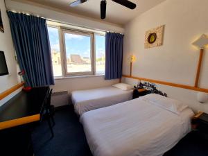 Postel nebo postele na pokoji v ubytování Arche Hotel