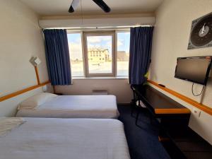 Postel nebo postele na pokoji v ubytování Arche Hotel