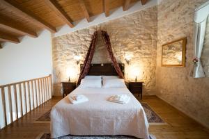 a bedroom with a bed in a stone wall at Casale 1821 in Ragusa +85 photos