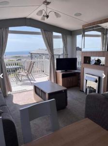 a living room with a view of the ocean at Platinum 3 Bedroom Caravan, Wifi, Parking, Seaview, in Budleigh Salterton