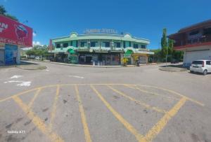 an empty parking lot in front of a building at Pandan Hotel in Papar