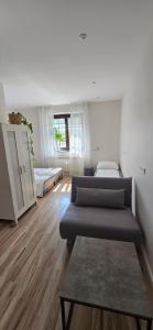 a room with three beds in it with wooden floors at Gościniec Husarski in Sandomierz