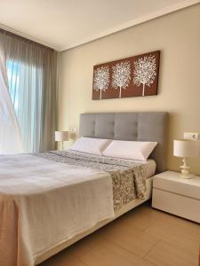 a bedroom with a large bed with white sheets at Spacious 2 Bedroom Flat in Playa de la Tejita in La Tejita