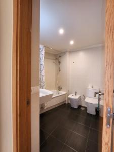 a bathroom with two toilets and a tub and a sink at Spacious 2 Bedroom Flat in Playa de la Tejita in La Tejita +14 photos