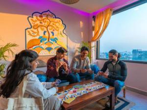 a group of people sitting around a table at The Hosteller Amritsar, Near Golden Temple in Amritsar