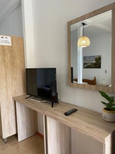 a television sitting on a wooden table in a room at 4 Seasons apartments in Himare
