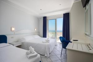 Postel nebo postele na pokoji v ubytování Hotel Oriente