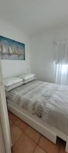 a bedroom with a bed with a white bedspread at House Feniks, 2 bedrooms, private parking, Starlink! in Milna