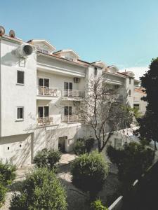 a white building with a tree in front of it at L'olive homes in Marmaris