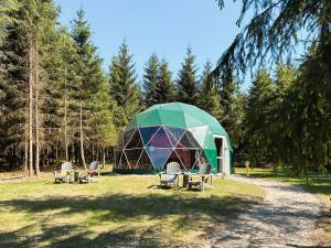 a dome house with chairs in front of it at High Moor Glamping in Jalhay