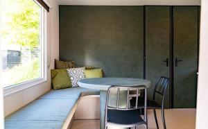 a table and chairs in a room with a window at Lodge Camping De la vallée in Durbuy