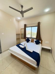 德瓦尔卡Hotel Darshan Palace - Near Dwarka Railway Station & Shree Dwarkadhish Temple的一间卧室配有一张带白色蛇床的卧室