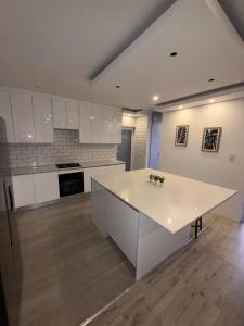 a kitchen with white cabinets and a white counter top at Skypool Guesthouse in Cape Town +9 photos
