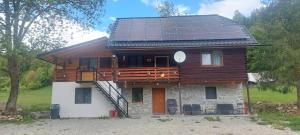 a house with solar panels on top of it at Casa de vacanță Mira in Cîmpu lui Neag