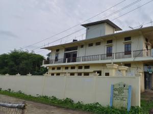 a large white building with a white fence in front of it at Protibha Homestay in Sibsāgar +13 photos