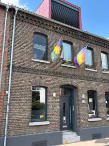 a brick building with flags on the side of it at Guestroom 10 in Willich in Willich
