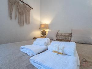 a bedroom with two beds with white sheets at Soft Comfort - Free Garage - Aria Condizionata - Smart TV in Varazze