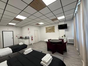 a room with two beds and a table in it at Loft Office in Castel Maggiore
