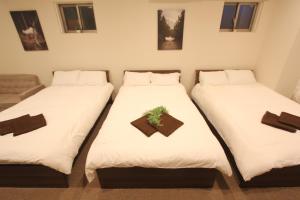 Letto o letti in una camera di LUANA in KOUENJI
