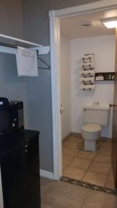 a bathroom with a white toilet and a sink at Motel West in Idaho Falls