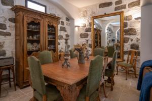 a dining room with a wooden table and chairs at Auberge U Mulinu in Casalabriva