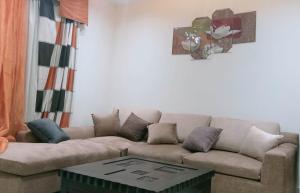 a living room with a couch and a coffee table at Porto Marina North Cost, Coastal Panorama in El Alamein