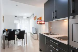 a kitchen with a table with chairs and a dining room at My Loft 4 You Na Jordana in Valencia