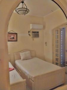a bedroom with two beds and an archway at Marina 5 مارينا in El Alamein