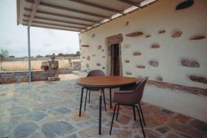 a table and chairs sitting on a patio at Mitatos "Matthew" in Moutsoúna