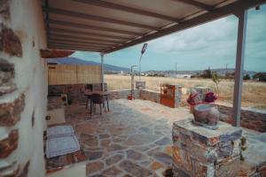 a patio with a table and a stone floor at Mitatos "Matthew" in Moutsoúna